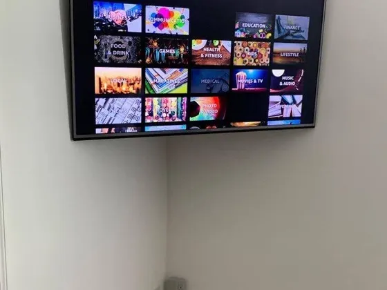 Corner-mounted TV with an internal power bridge