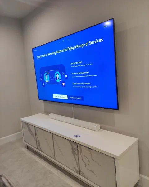 TV installed on a full-motion mount with a cable cover strip