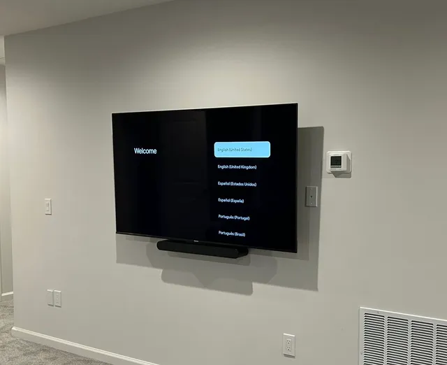 TV mounted with a soundbar on a full-motion mount
