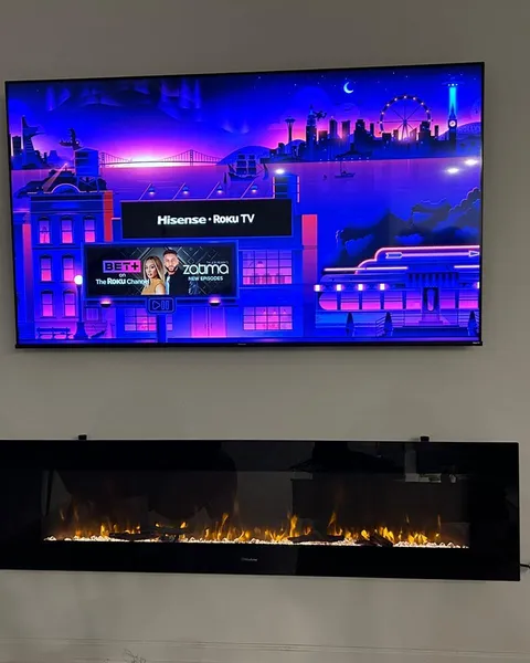 TV installed on a tilt mount above a fireplace